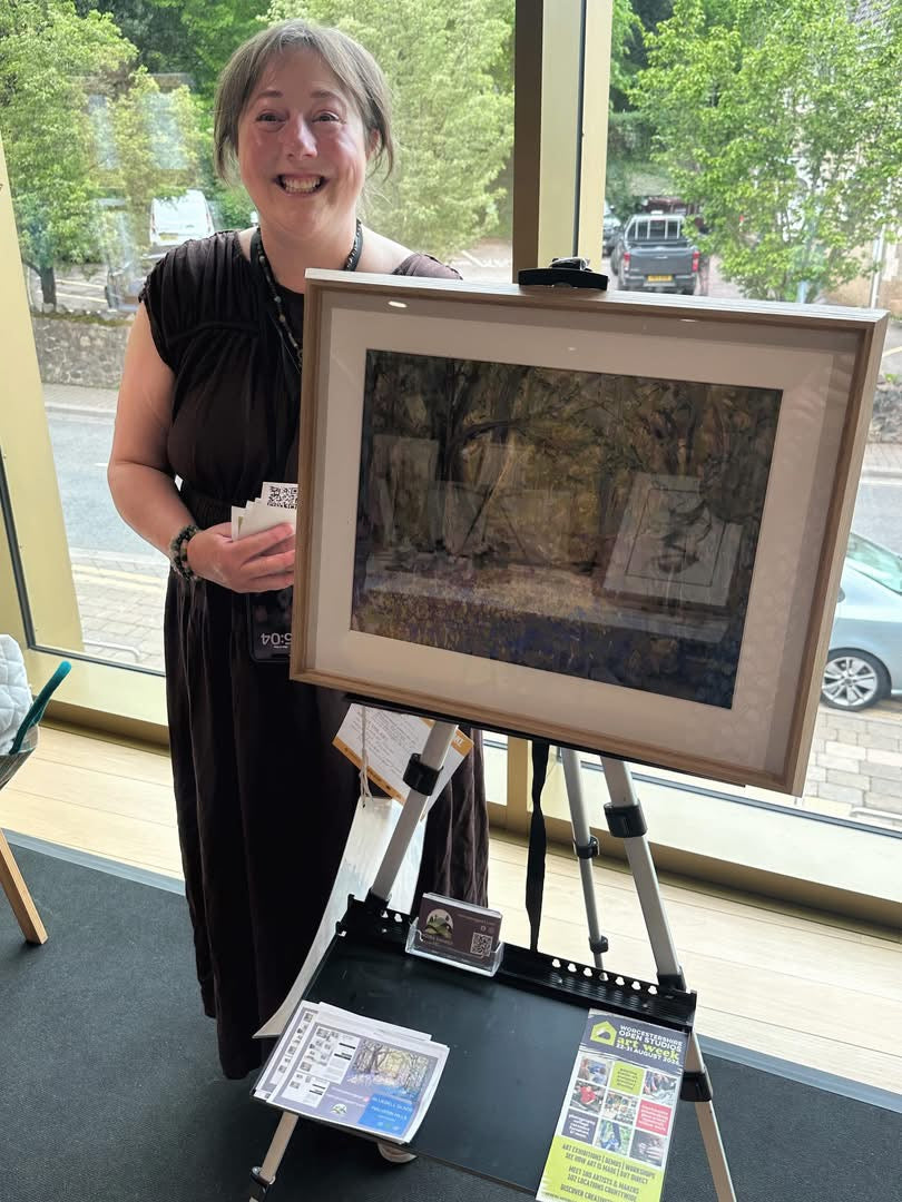 Moira Savage with exhibition painting in Malvern, Worcestershire